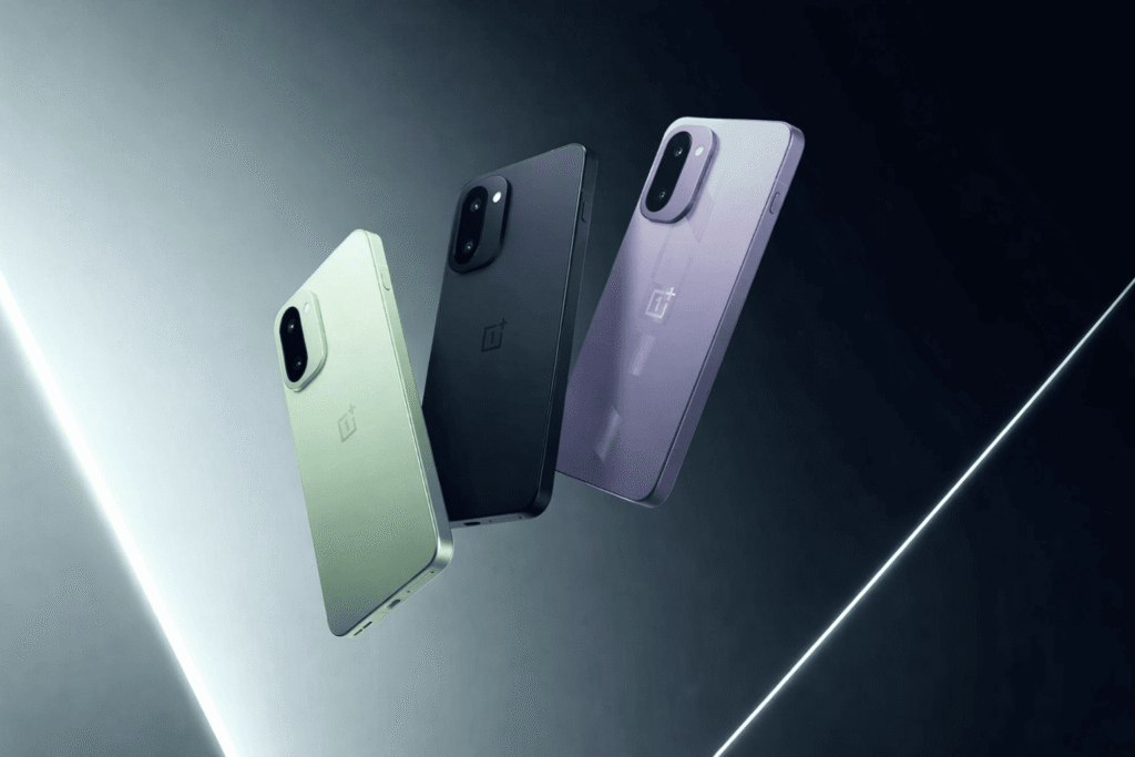 Three OnePlus 15R smartphones shown in Mint Breeze, Charcoal Black, and the India-exclusive Electric Violet colors, featuring a new camera module design and flat edges.