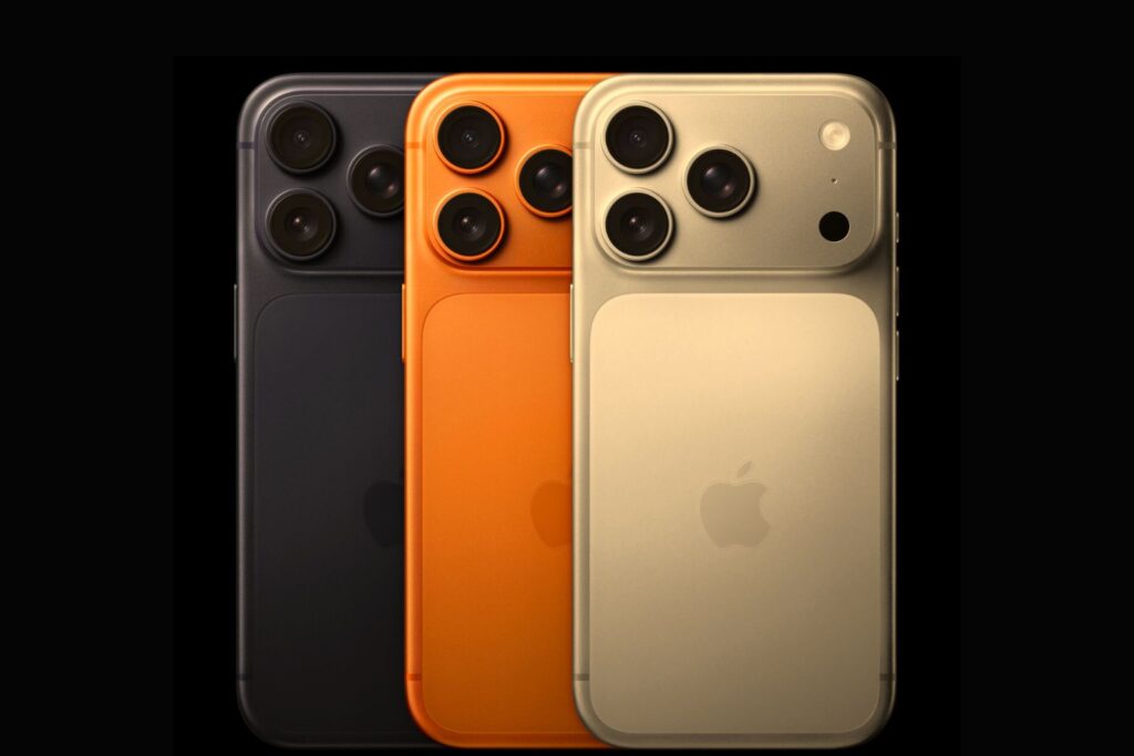 Three Apple iPhone 17 Pro Max models in Space Black, Cosmic Orange, and Desert Titanium shown from the back, highlighting the new triple-camera array and sleek matte finish.