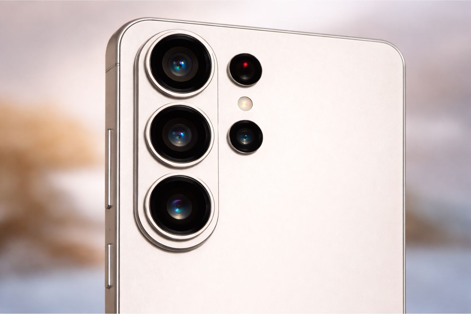 "Close-up macro image of the Samsung Galaxy S26 Ultra rear camera module showing three large circular lenses, additional sensors, and an LED flash on a matte silver back panel."