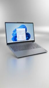 A silver Lenovo Yoga laptop floating in the top half of a vertical Instagram story-sized frame. The background is a sleek, vibrant silver metallic gradient with professional product lighting, leaving ample empty space at the bottom for text overlays.