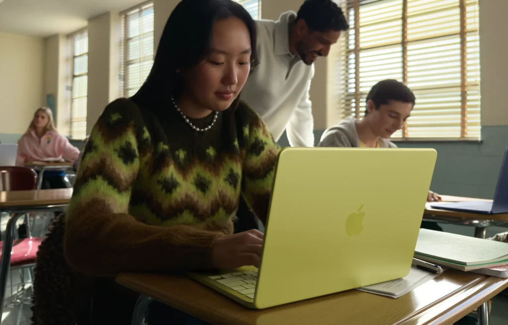 Apple MacBook Neo in Citrus yellow colour being used by a student in a classroom